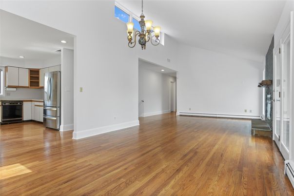 Chandelier, Empty room, Interior, Kitchen, Recessed Lighting, Stainless Steel Appliances, Wood Texture Flooring