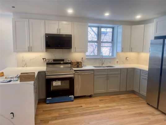 Interior, Kitchen, Marble Walls, Recessed Lighting, Stainless Steel Appliances, Wood Texture Flooring