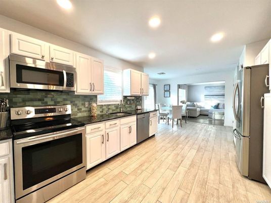 Dining room, Interior, Kitchen, Living room, Recessed Lighting, Stainless Steel Appliances, Wood Texture Flooring