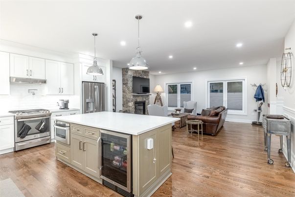 Fireplace, Interior, Kitchen, Living room, Pendant Lights, Recessed Lighting, Stainless Steel Appliances, Stone Walls, Wood Texture Flooring