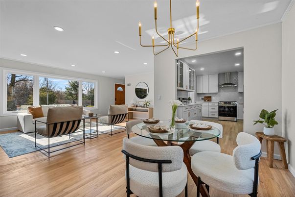 Chandelier, Dining room, Interior, Kitchen, Living room, Pendant Lights, Recessed Lighting, Stainless Steel Appliances, Wood Texture Flooring