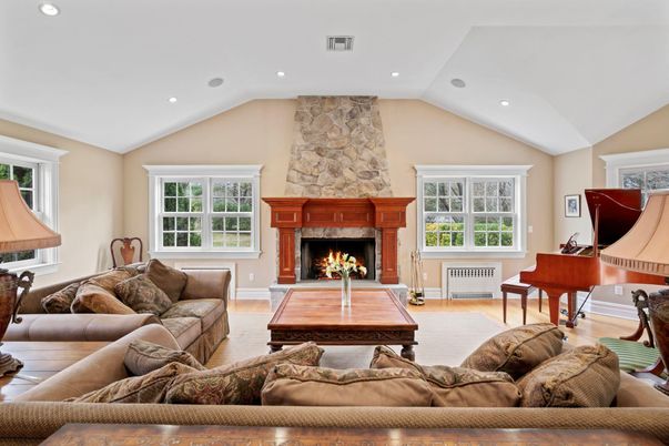 Fireplace, Interior, Living room, Piano, Recessed Lighting, Stone Walls, Wood Texture Flooring