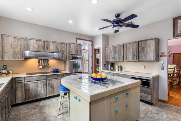 Interior, Kitchen, Recessed Lighting, Stainless Steel Appliances, Tile Countertops, Wood Texture Flooring