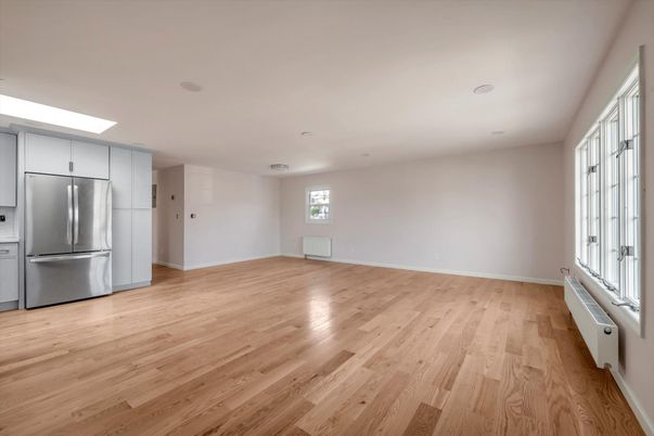 Empty room, Interior, Kitchen, Recessed Lighting, Stainless Steel Appliances, Wood Texture Flooring