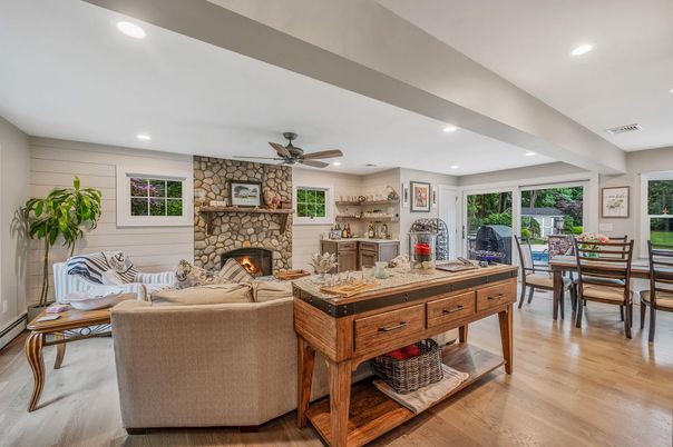 Dining room, Fireplace, Interior, Living room, Recessed Lighting, Stone Walls, Wood Texture Flooring