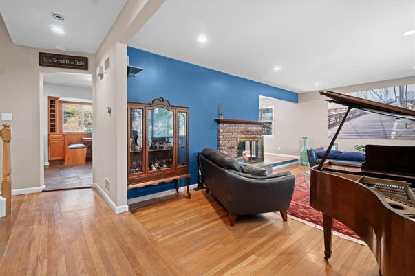 Fireplace, Interior, Living room, Piano, Recessed Lighting, Wood Texture Flooring