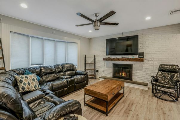 Fireplace, Interior, Living room, Recessed Lighting, Stone Walls, Wood Texture Flooring