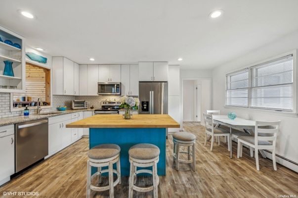 Dining room, Interior, Kitchen, Recessed Lighting, Stainless Steel Appliances, Wood Texture Flooring