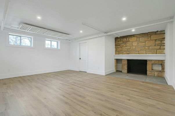 Empty room, Fireplace, Interior, Recessed Lighting, Stone Walls, Wood Texture Flooring