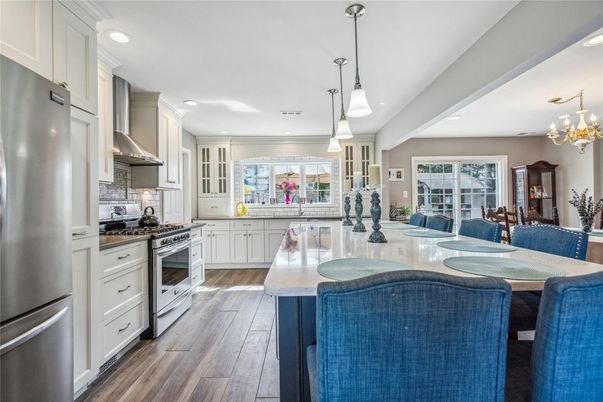 Chandelier, Dining room, Interior, Kitchen, Living room, Pendant Lights, Recessed Lighting, Stainless Steel Appliances, Wood Texture Flooring