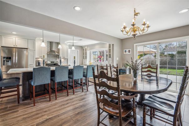 Chandelier, Dining room, Interior, Kitchen, Pendant Lights, Recessed Lighting, Stainless Steel Appliances, Wood Texture Flooring