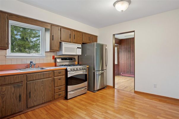 Interior, Kitchen, Stainless Steel Appliances, Tile Countertops, Wood Texture Flooring