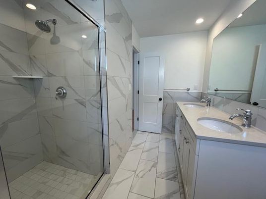 Bathroom, Dual Sink Vanities, Glass Shower, Interior, Marble, Marble Walls, Recessed Lighting