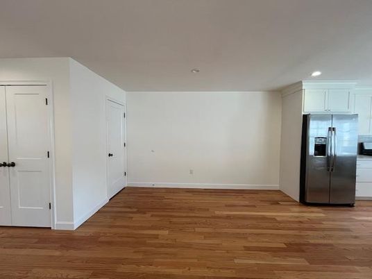 Empty room, Interior, Kitchen, Recessed Lighting, Stainless Steel Appliances, Wood Texture Flooring