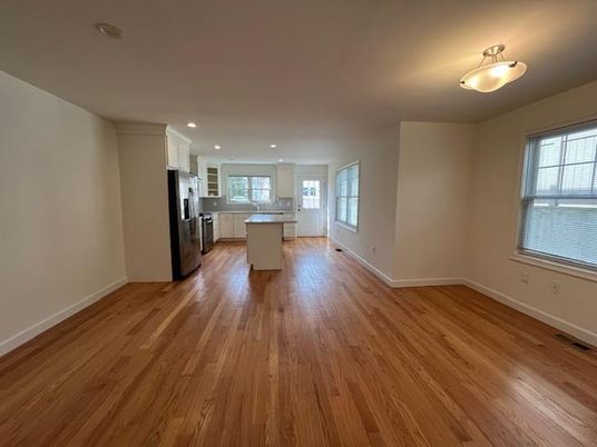 Empty room, Interior, Kitchen, Recessed Lighting, Stainless Steel Appliances, Wood Texture Flooring