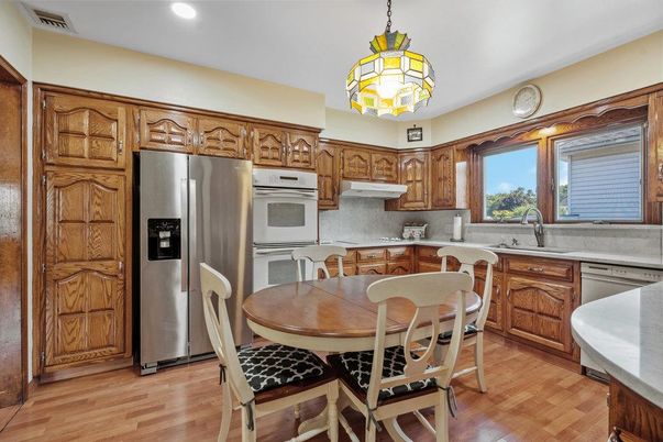 Dining room, Interior, Kitchen, Pendant Lights, Recessed Lighting, Stainless Steel Appliances, Wood Texture Flooring