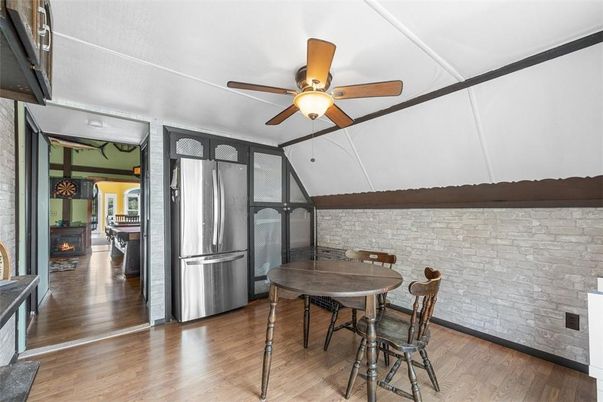 Dining room, Fireplace, Interior, Kitchen, Stainless Steel Appliances, Stone Walls, Wood Texture Flooring