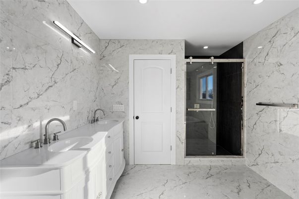 Bathroom, Dual Sink Vanities, Glass Shower, Interior, Marble, Marble Walls, Recessed Lighting