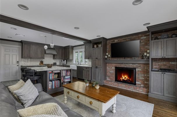 Fireplace, Interior, Kitchen, Living room, Pendant Lights, Recessed Lighting, Stainless Steel Appliances, Stone Walls, Wood Texture Flooring