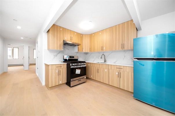 Interior, Kitchen, Marble Walls, Recessed Lighting, Stainless Steel Appliances, Wood Texture Flooring