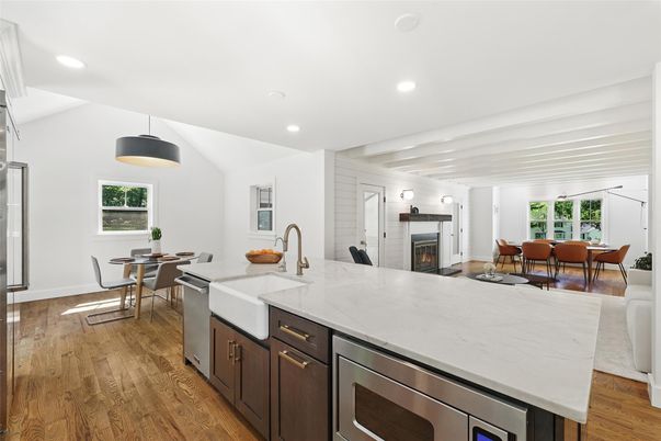 Dining room, Fireplace, Interior, Kitchen, Pendant Lights, Recessed Lighting, Stainless Steel Appliances, Wood Texture Flooring