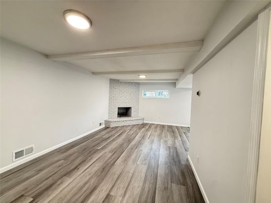 Empty room, Fireplace, Interior, Recessed Lighting, Stone Walls, Wood Texture Flooring