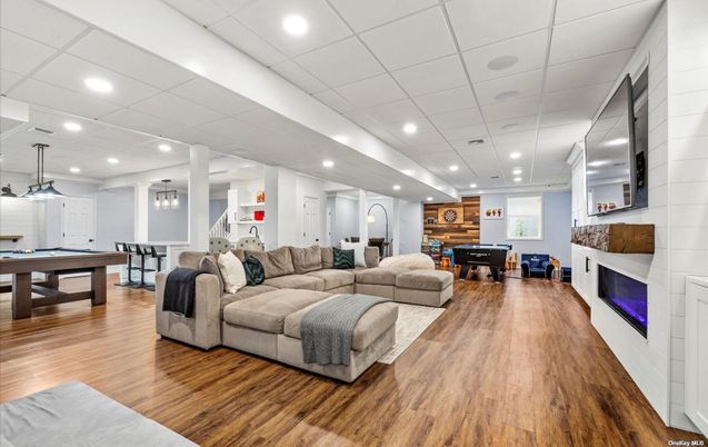 Billiard Table, Dining room, Fireplace, Game Room, Interior, Living room, Pendant Lights, Recessed Lighting, Wood Texture Flooring