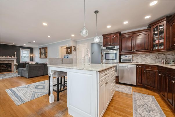 Fireplace, Interior, Kitchen, Living room, Pendant Lights, Recessed Lighting, Stainless Steel Appliances, Wood Texture Flooring