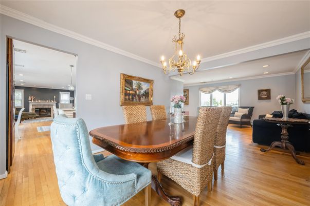 Chandelier, Dining room, Fireplace, Interior, Living room, Pendant Lights, Recessed Lighting, Wood Texture Flooring