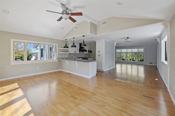 Empty room, Interior, Kitchen, Recessed Lighting, Stainless Steel Appliances, Wood Texture Flooring