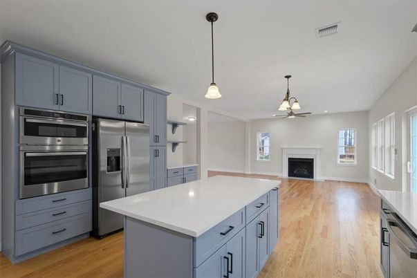 Fireplace, Interior, Kitchen, Pendant Lights, Recessed Lighting, Stainless Steel Appliances, Wood Texture Flooring