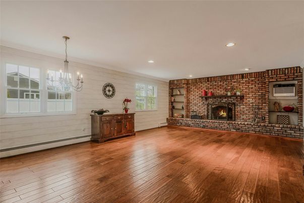 Chandelier, Empty room, Fireplace, Interior, Recessed Lighting, Stone Walls, Wood Texture Flooring