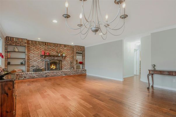 Chandelier, Empty room, Fireplace, Interior, Recessed Lighting, Stone Walls, Wood Texture Flooring