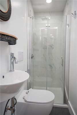 Bathroom, Glass Shower, Interior, Marble Walls, Recessed Lighting, Wood Texture Flooring