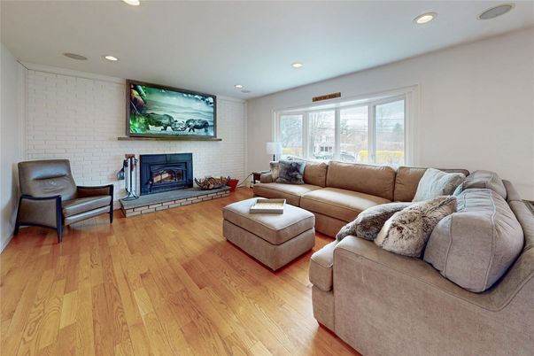 Fireplace, Interior, Living room, Recessed Lighting, Stone Walls, Wood Texture Flooring