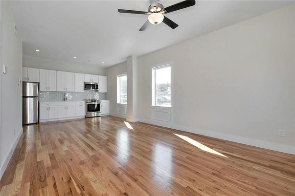 Empty room, Interior, Kitchen, Recessed Lighting, Stainless Steel Appliances, Wood Texture Flooring