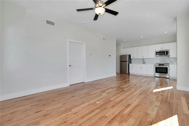 Empty room, Interior, Kitchen, Recessed Lighting, Stainless Steel Appliances, Wood Texture Flooring