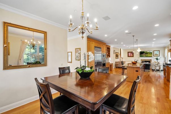 Chandelier, Dining room, Interior, Kitchen, Living room, Pendant Lights, Recessed Lighting, Stainless Steel Appliances, Wood Texture Flooring