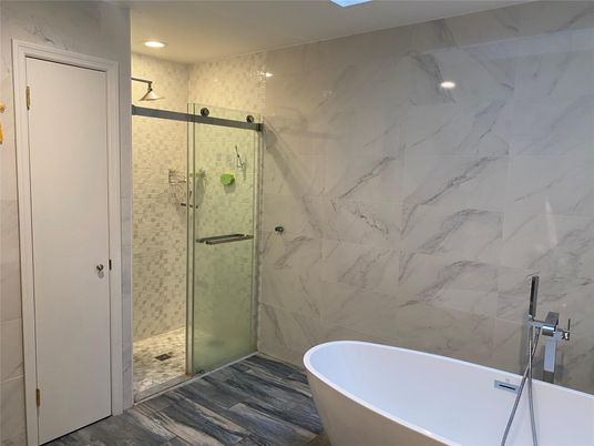 Bathroom, Free Standing Baths, Glass Shower, Interior, Marble Walls, Recessed Lighting, Wood Texture Flooring