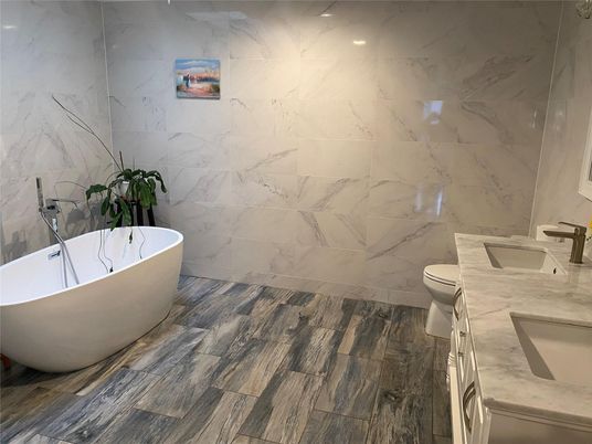Bathroom, Dual Sink Vanities, Free Standing Baths, Interior, Marble Walls, Recessed Lighting, Wood Texture Flooring