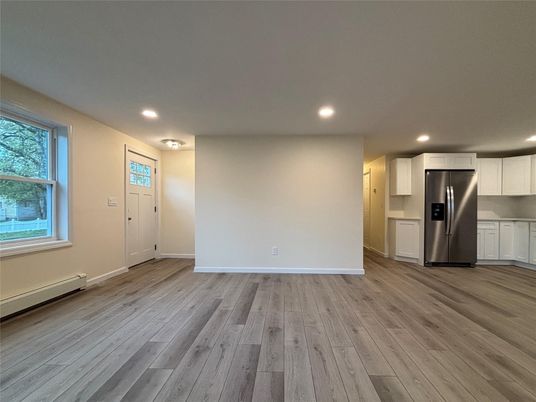 Empty room, Interior, Kitchen, Recessed Lighting, Stainless Steel Appliances, Wood Texture Flooring