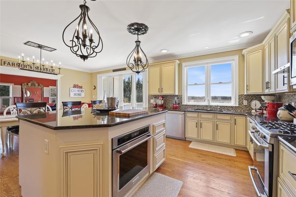 Chandelier, Dining room, Interior, Kitchen, Pendant Lights, Recessed Lighting, Stainless Steel Appliances, Wood Texture Flooring