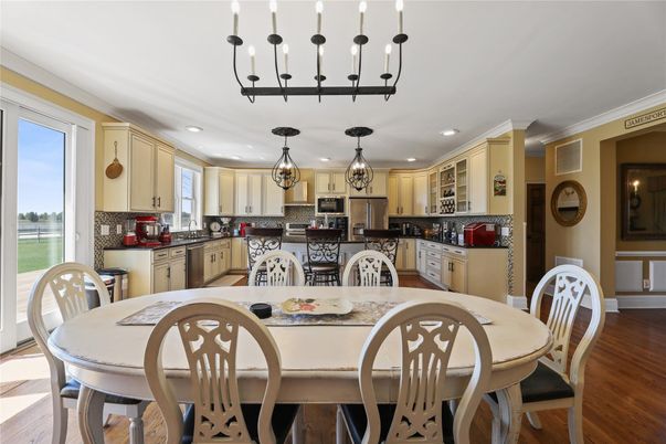 Chandelier, Dining room, Interior, Kitchen, Pendant Lights, Recessed Lighting, Stainless Steel Appliances, Wood Texture Flooring