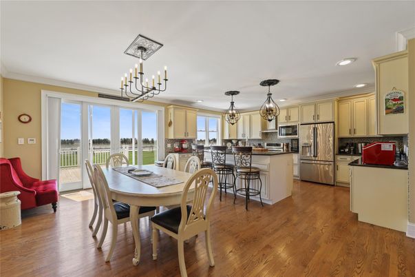 Chandelier, Dining room, Interior, Kitchen, Pendant Lights, Recessed Lighting, Stainless Steel Appliances, Wood Texture Flooring