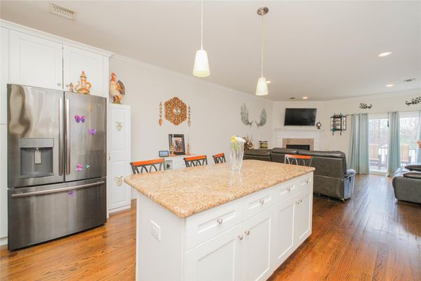 Fireplace, Interior, Kitchen, Living room, Pendant Lights, Recessed Lighting, Stainless Steel Appliances, Wood Texture Flooring