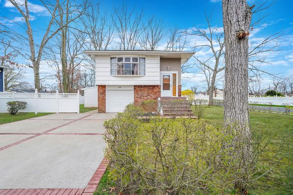 Attached, Backyard, Exterior, Facade, Brick Facade, Raised Ranch