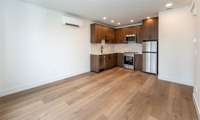 Interior, Kitchen, Marble Walls, Recessed Lighting, Stainless Steel Appliances, Wood Texture Flooring