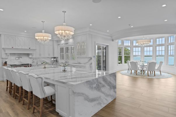 Chandelier, Dining room, Interior, Kitchen, Marble Walls, Recessed Lighting, Stainless Steel Appliances, Water, Wood Texture Flooring