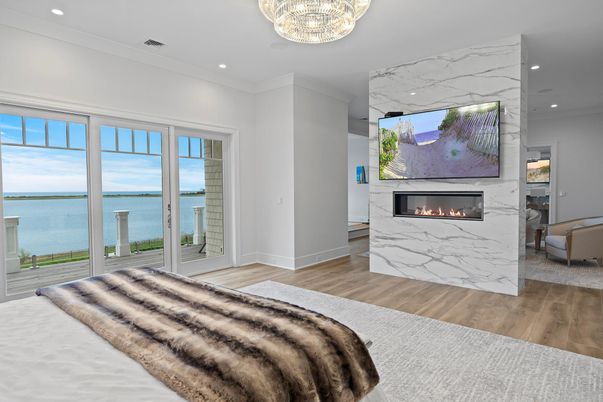 Bedroom, Chandelier, Fireplace, Interior, Marble Walls, Recessed Lighting, Water, Wood Texture Flooring