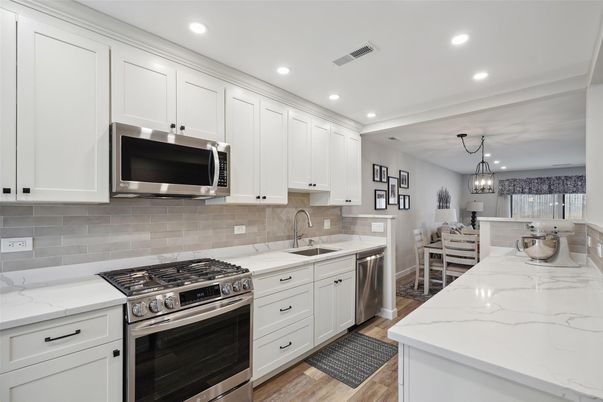 Chandelier, Dining room, Interior, Kitchen, Pendant Lights, Recessed Lighting, Stainless Steel Appliances, Wood Texture Flooring